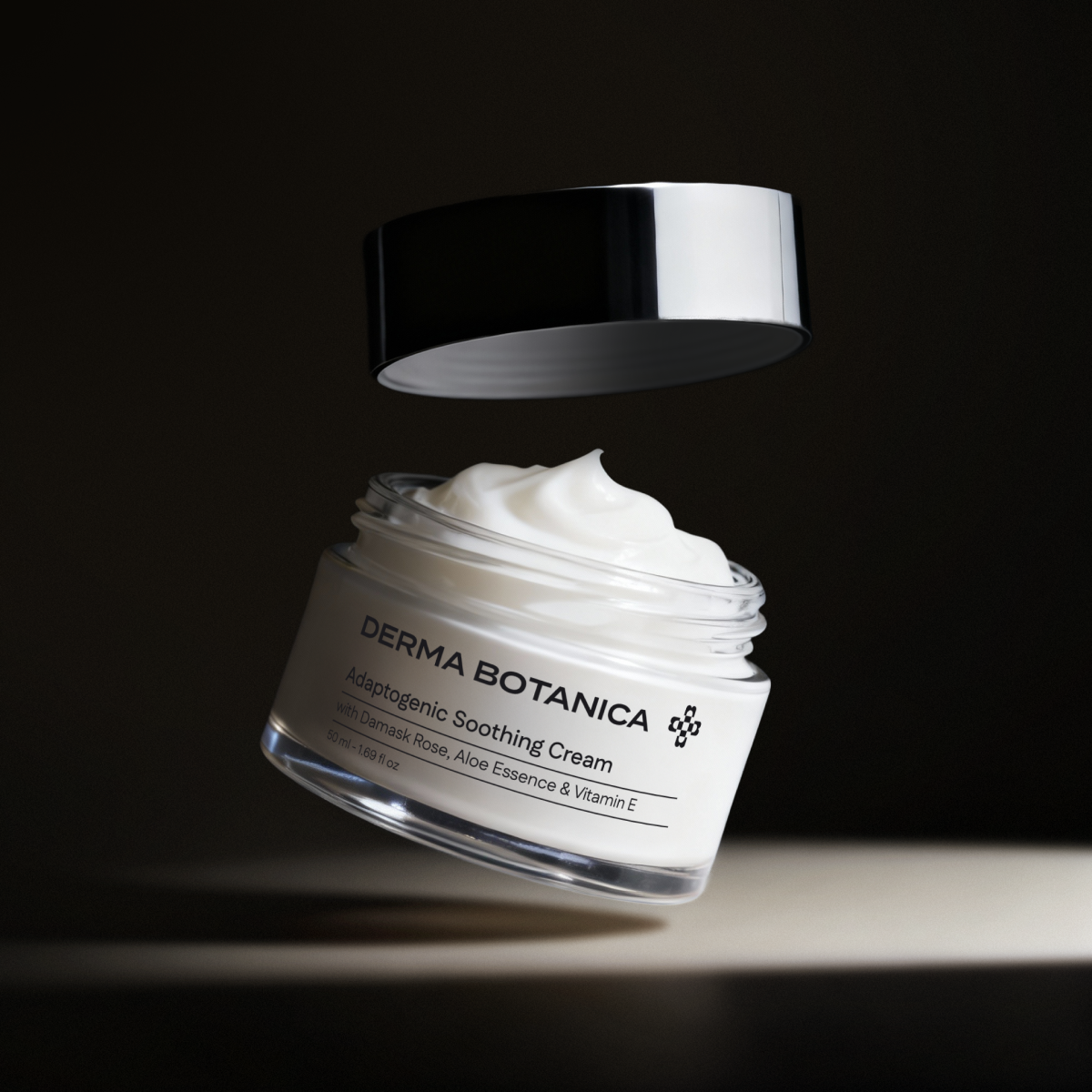 Derma Botanica Adaptogenic Soothing Cream with open lid on a black background in a studio setting