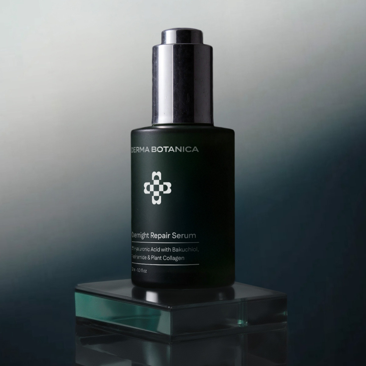 Derma Botanica Overnight Repair Serum bottle on a reflective surface with a gradient background